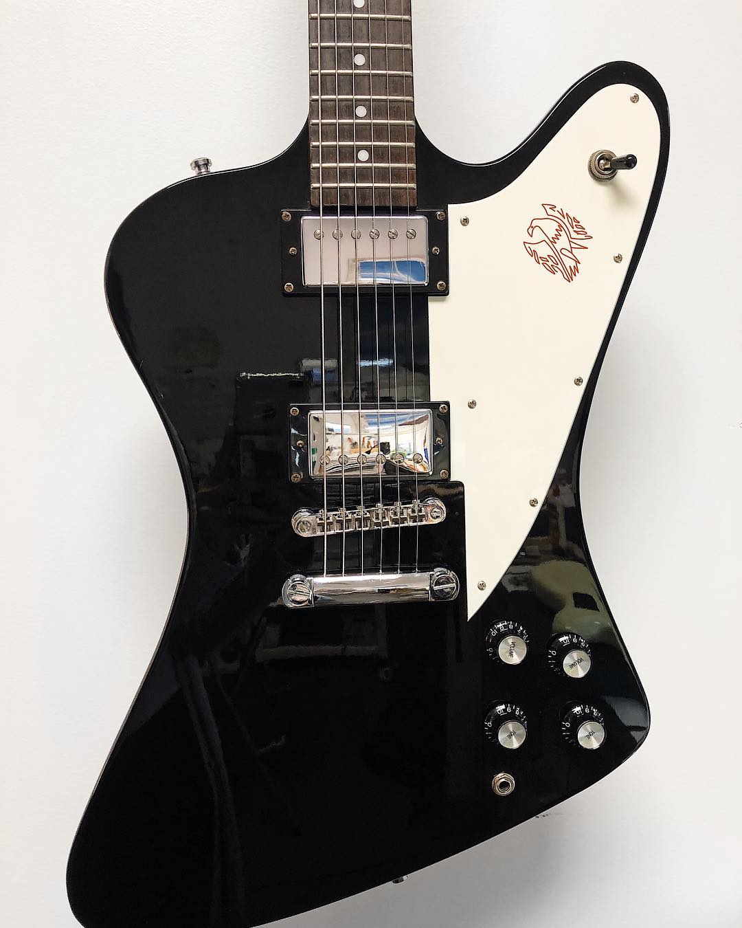 Close-up of a Firebird guitar with chrome pickups