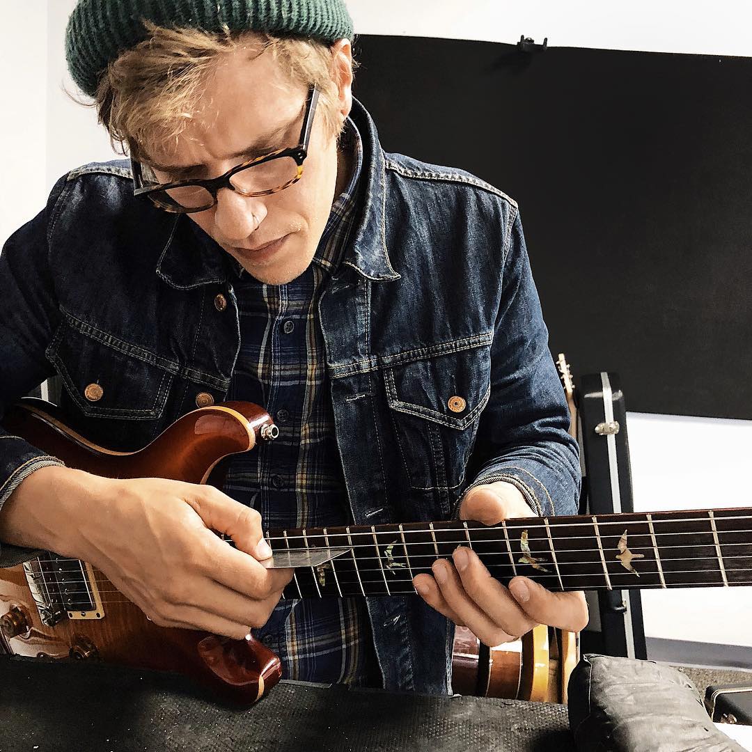 Musician playing a custom bass guitar