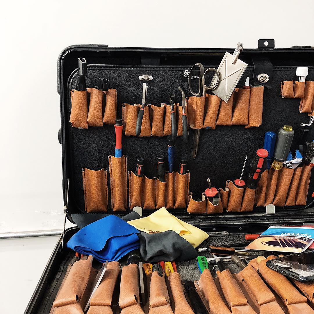 Aron Robbins working on a guitar